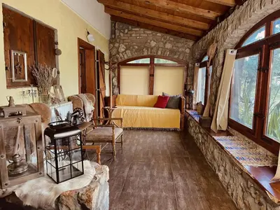 a living room with a couch and a bed in a room at Village house Velimirović in Danilovgrad