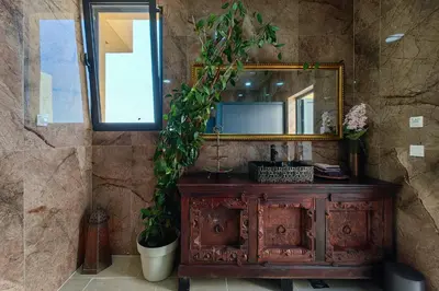 a bathroom with a mirror and a wooden dresser at Solana's View - Ferienhäuser in ruhiger Lage, mit einer einzigartigen Aussicht, Infinity Pool, Free Parking und Wlan in Ulcinj