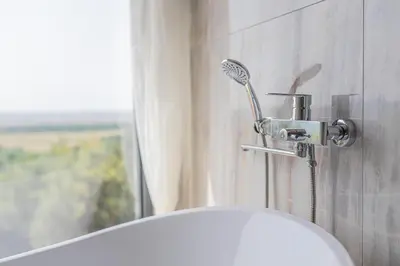 a shower head next to a toilet in a bathroom at Solana's View - Ferienhäuser in ruhiger Lage, mit einer einzigartigen Aussicht, Infinity Pool, Free Parking und Wlan in Ulcinj