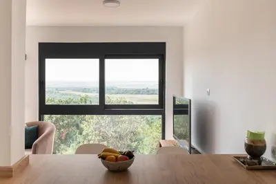 a dining room table with a bowl of fruit in front of a window at Solana's View - Ferienhäuser in ruhiger Lage, mit einer einzigartigen Aussicht, Infinity Pool, Free Parking und Wlan in Ulcinj