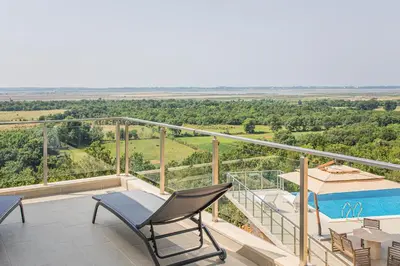 a view from the balcony of a house with a swimming pool at Solana's View - Ferienhäuser in ruhiger Lage, mit einer einzigartigen Aussicht, Infinity Pool, Free Parking und Wlan in Ulcinj