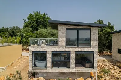 a house with a view of the backyard at Solana's View - Ferienhäuser in ruhiger Lage, mit einer einzigartigen Aussicht, Infinity Pool, Free Parking und Wlan in Ulcinj