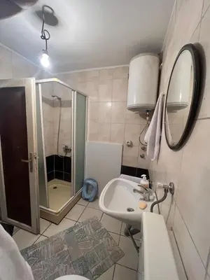a bathroom with a shower and a sink and a mirror at Purple Eye Camp & Winery in Podgorica