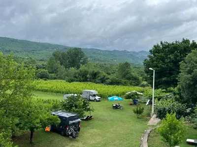 a view of a yard with a campsite and a car parked at Purple Eye Camp & Winery in Podgorica