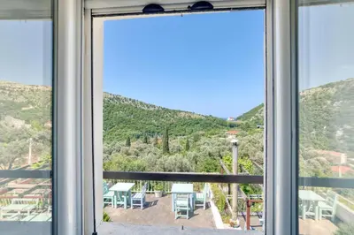a window with a view of a mountain view at Eva's country house in Buljarica