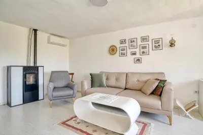 a living room with a couch and a chair at Eva's country house in Buljarica