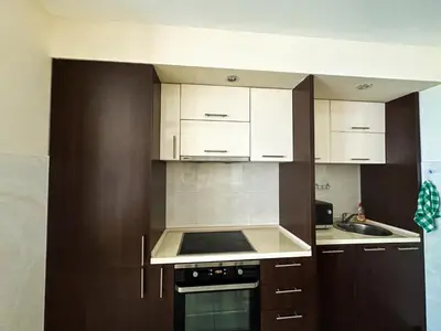 a kitchen with white cabinets and a stove top oven at BigMontenegro Shine in Budva