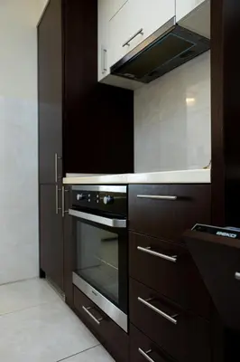 a kitchen with brown cabinets and an oven at BigMontenegro Shine in Budva