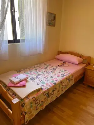 a bedroom with a bed with two towels on it at DOLCE NOTTE rooms in Virpazar