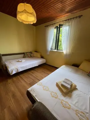 a bedroom with two beds and a window at DOLCE NOTTE rooms in Virpazar