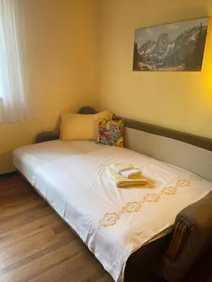 a bed with two books on it in a room at DOLCE NOTTE rooms in Virpazar