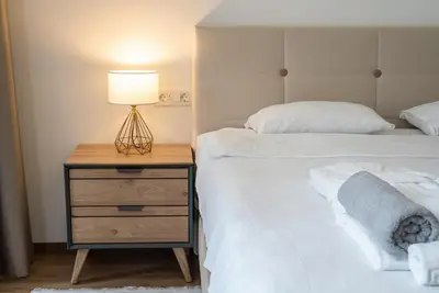 a bedroom with two beds and a lamp on a night stand at Villa Cape Montenegro on Cliffside in Kotor