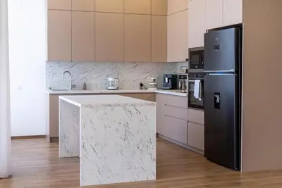 a kitchen with a black refrigerator and a marble counter at Villa Cape Montenegro on Cliffside in Kotor