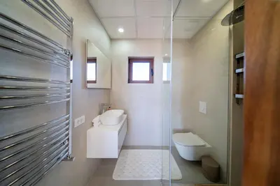 a bathroom with a toilet and a glass shower at Villa Cape Montenegro on Cliffside in Kotor