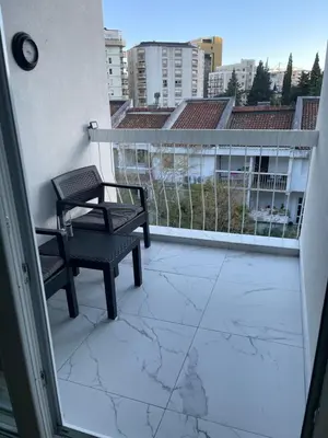 a balcony with a bench and a view of a city at Apartment Ritter in Budva