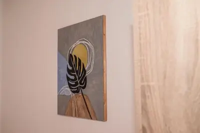 a painting of a mirror hanging on a wall at Adriatic Sea View Rooms in Ulcinj