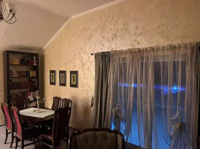 a dining room with a table and a window at Pool & River House - Lazara in Danilovgrad