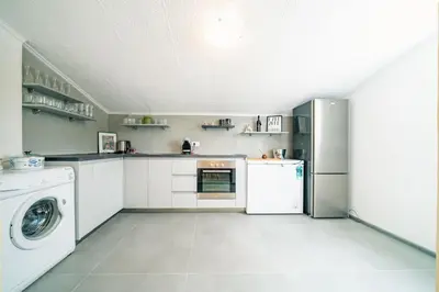 a kitchen with a refrigerator and a washer and dryer at Pool & River House - Lazara in Danilovgrad