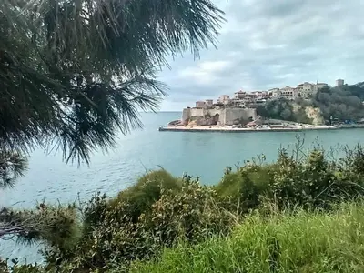 an island in the middle of a body of water at The sun is happiness in Ulcinj
