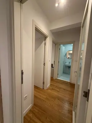 an empty hallway with a door leading to a bathroom at White Homes 45 • Central Point in Podgorica