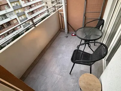 a balcony with two chairs and a table at White Homes 45 • Central Point in Podgorica