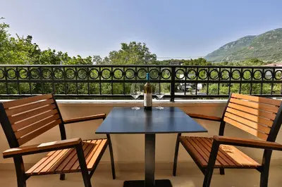 a table and two chairs on a balcony at Villa La Vida in Budva