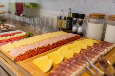 a bunch of different types of cheese and meats at Villa La Vida in Budva