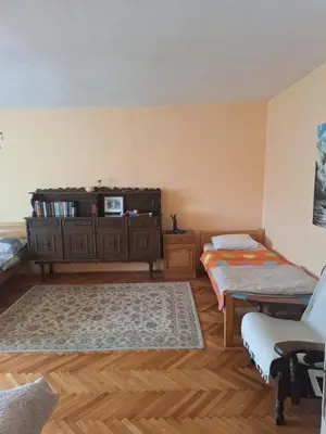 a living room with a dresser and a bed at Apartman Boljević in Podgorica