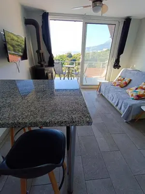 a room with a table and a bed and a large window at Carefree Apartments in Ulcinj