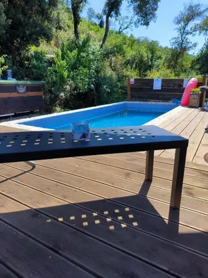 a blue bench sitting next to a swimming pool at Carefree Apartments in Ulcinj