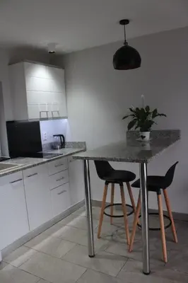 a kitchen with a table and two chairs and a counter at Carefree Apartments in Ulcinj