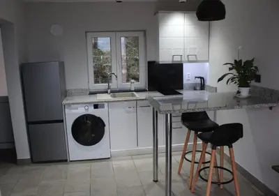 a kitchen with a sink and a washing machine at Carefree Apartments in Ulcinj