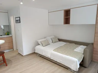 a small bedroom with a bed and a kitchen at Studio Apartment Danka Old Town Budva in Budva