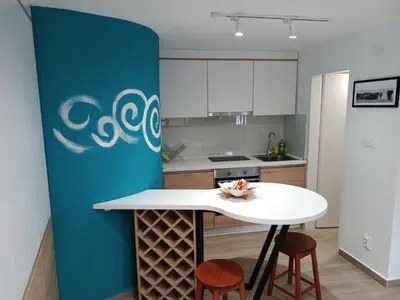 a kitchen with a white counter and a blue wall at Studio Apartment Danka Old Town Budva in Budva