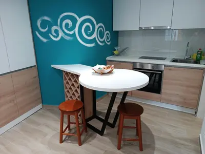 a kitchen with a white table and two stools at Studio Apartment Danka Old Town Budva in Budva