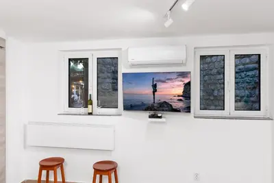 a kitchen with two chairs and two windows at Studio Apartment Danka Old Town Budva in Budva