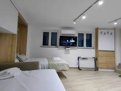 a room with two beds and a tv on the wall at Studio Apartment Danka Old Town Budva in Budva