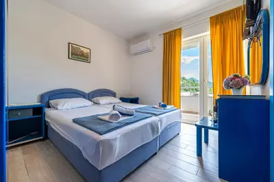 a bedroom with a bed and a large window at MAS Apartments in Kotor