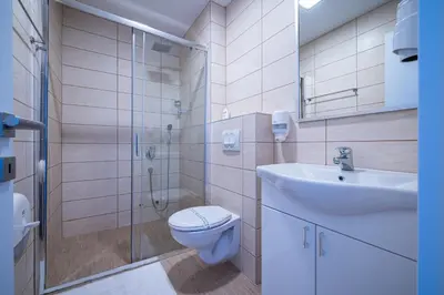 a bathroom with a toilet and a sink and a shower at MAS Apartments in Kotor