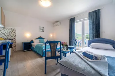 a bedroom with two beds and a balcony at MAS Apartments in Kotor