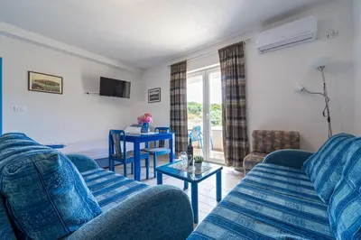 a living room with blue couches and a table at MAS Apartments in Kotor