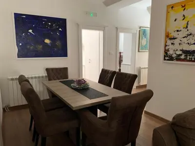 a dining room with a table and chairs at D&D apartments in Sutomore