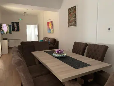 a living room with a dining room table and chairs at D&D apartments in Sutomore