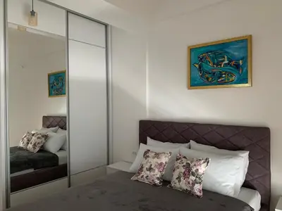 a bedroom with a mirror and a bed with pillows at D&D apartments in Sutomore