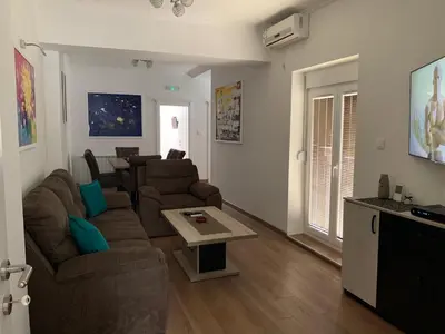 a living room with a couch and a table at D&D apartments in Sutomore