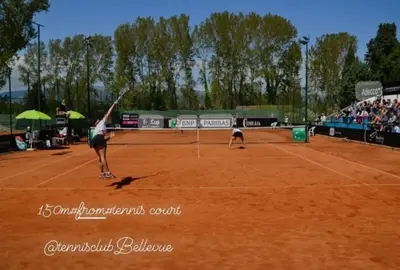 a woman serving a tennis ball on a tennis court at Garden Apartments in Ulcinj