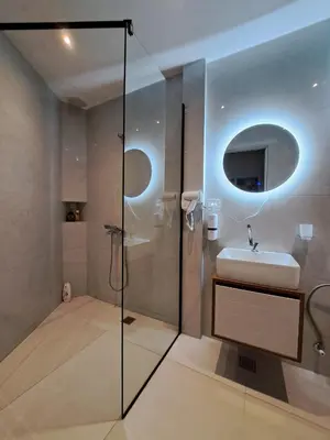 a bathroom with a shower and a sink and a sink at Garden Apartments in Ulcinj