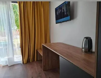 a room with a desk with a television and a window at Garden Apartments in Ulcinj