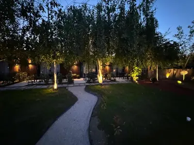 a walkway in a yard at night at Garden Apartments in Ulcinj