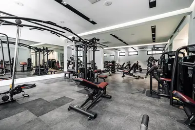 a gym with several treadmills and machines at Status-M Apartments 89 in Becici